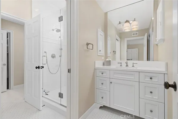a bathroom with a double vanity sink mirror and