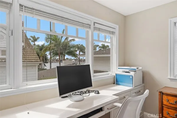 a view of a dining room with furniture a livingroom and chandelier