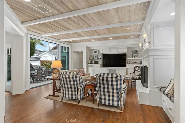 a living room with furniture fireplace and flat screen tv