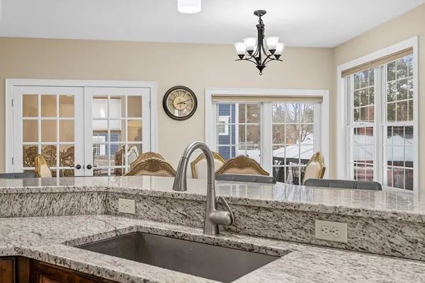 a kitchen with a refrigerator a sink and a large window