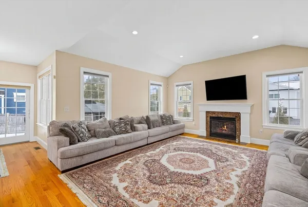 a living room with furniture a flat screen tv and a fireplace