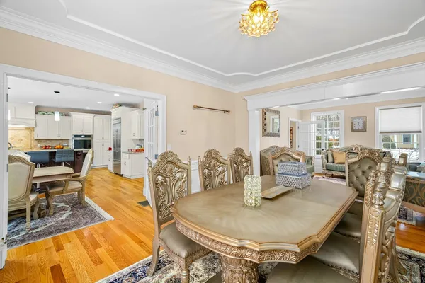 a dining room with furniture and a chandelier