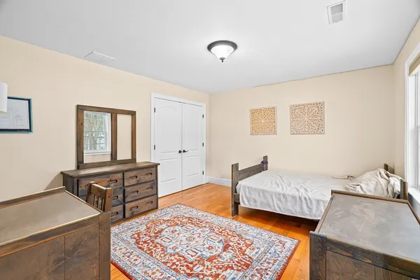 a bedroom with furniture and a wooden floor