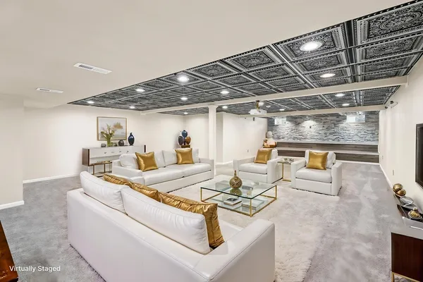 a living room with furniture and kitchen view