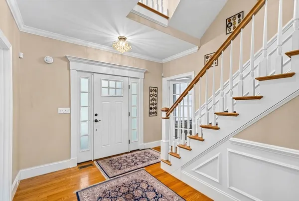 a view of entryway and hall with wooden floor