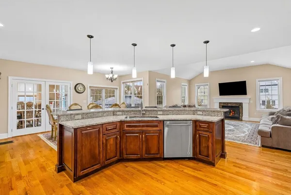 a large kitchen with stainless steel appliances granite countertop a stove and large center island