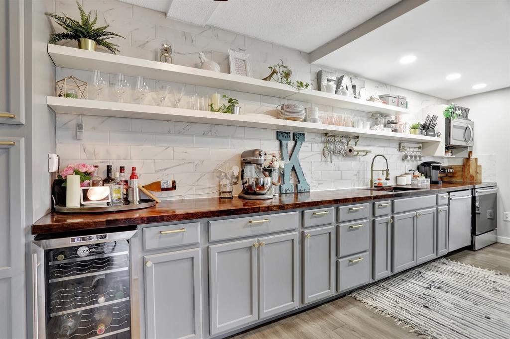 a kitchen with cabinets a sink and wooden floor