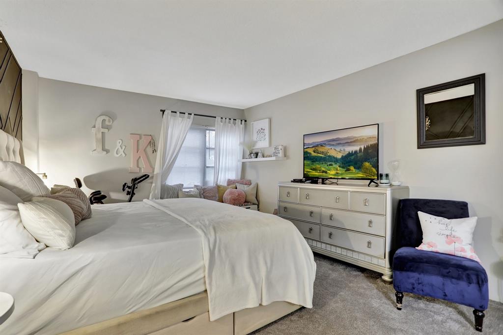 4160 Inverrary Drive, Unit 402 Lauderhill, FL 33319 - Photo 12 of 24 a bedroom with a bed and a flat screen tv