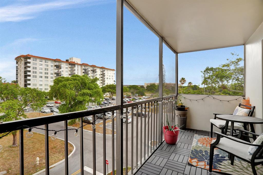 4160 Inverrary Drive, Unit 402 Lauderhill, FL 33319 - Photo 23 of 24 a balcony with wooden floor and outdoor seating