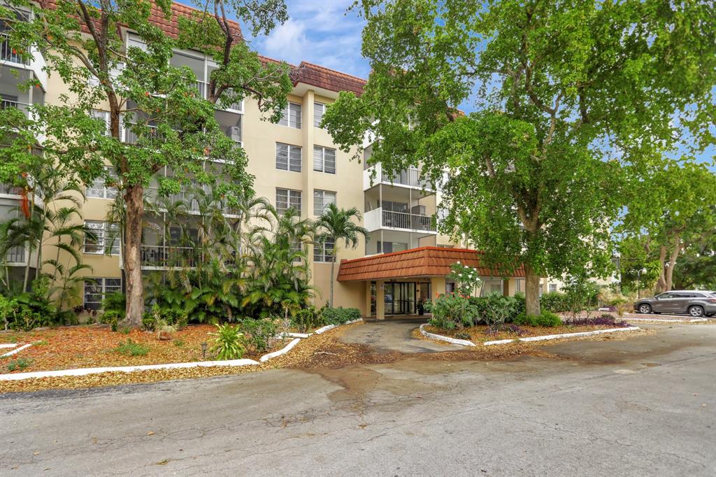 4160 Inverrary Drive, Unit 402 Lauderhill, FL 33319 - Photo 24 of 24 a front view of a house with a yard and fountain