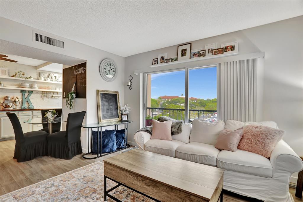 4160 Inverrary Drive, Unit 402 Lauderhill, FL 33319 - Photo 3 of 24 a living room with furniture two window and a fireplace