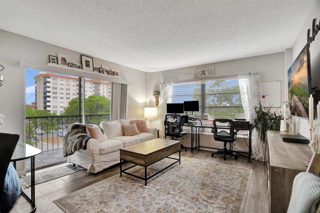 4160 Inverrary Drive, Unit 402 Lauderhill, FL 33319 - Photo 4 of 24 a living room with furniture and a flat screen tv