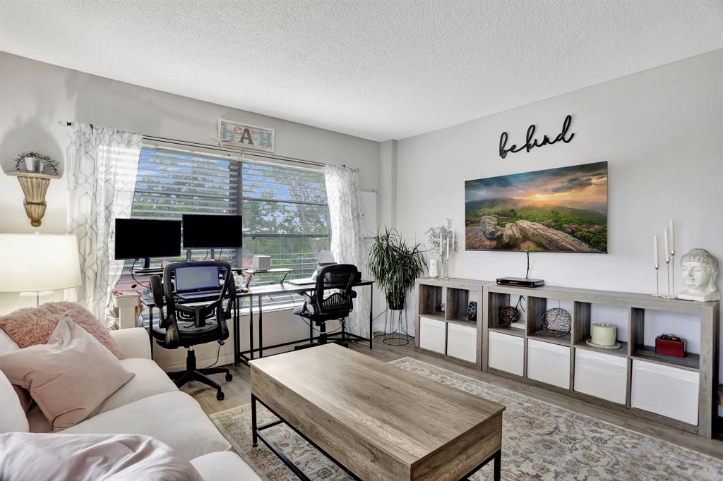 4160 Inverrary Drive, Unit 402 Lauderhill, FL 33319 - Photo 6 of 24 a living room with furniture and a flat screen tv
