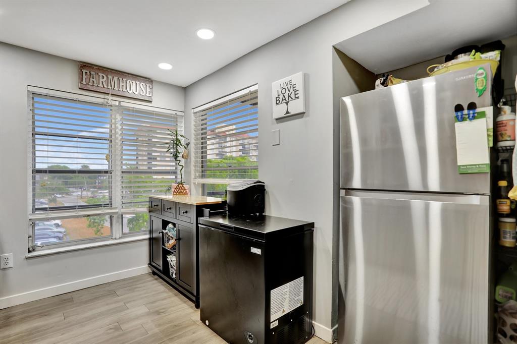 4160 Inverrary Drive, Unit 402 Lauderhill, FL 33319 - Photo 9 of 24 a kitchen with stainless steel appliances granite countertop a refrigerator and a stove top oven