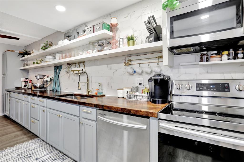 4160 Inverrary Drive, Unit 402 Lauderhill, FL 33319 - Photo 10 of 24 a kitchen with stainless steel appliances granite countertop a sink and wooden cabinets
