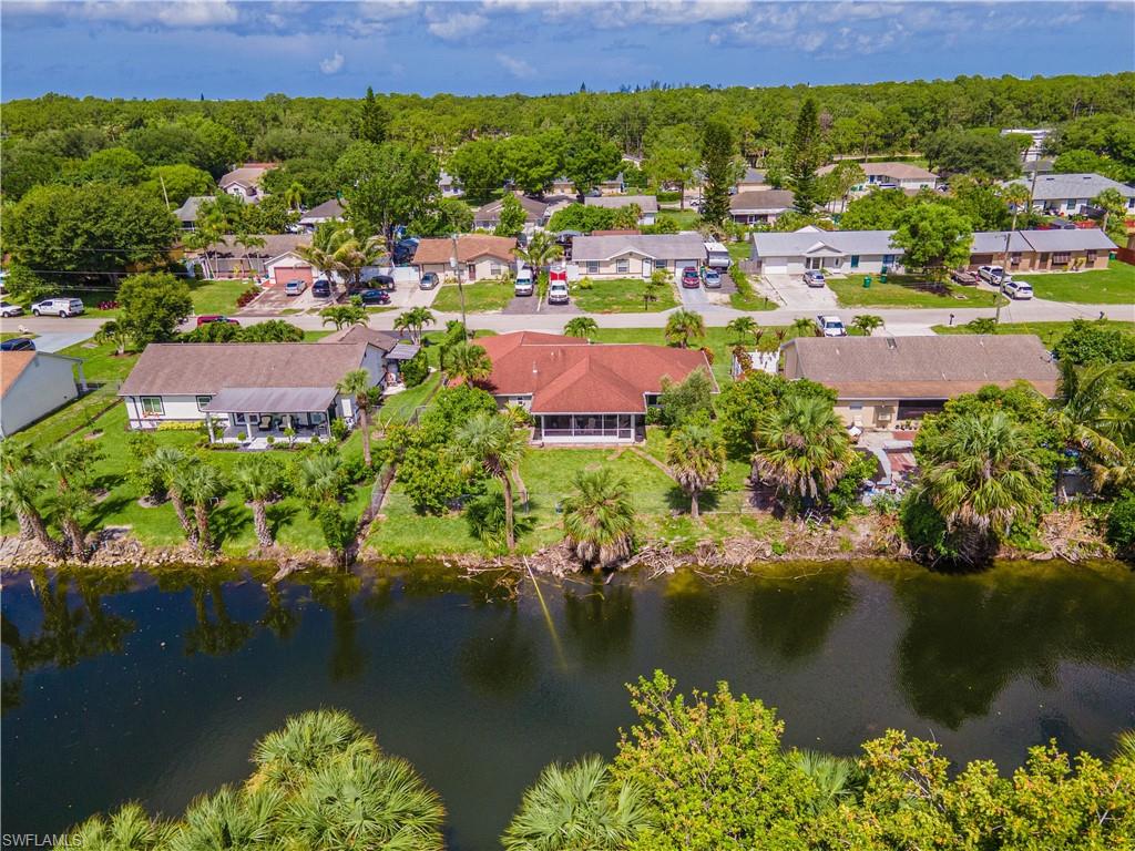 2100 55th Street Southwest Naples, FL 34116 - Photo 16 of 50 an aerial view of residential houses with outdoor space and lake view