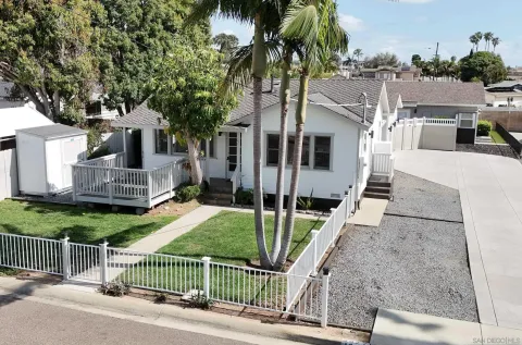 a view of a house with a yard and furniture