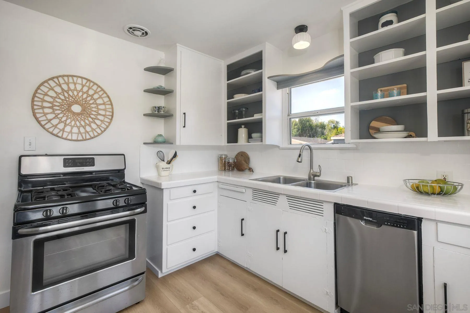 1027 Knowles Avenue Carlsbad, CA 92008 - Photo 12 of 42 a kitchen with stainless steel appliances a stove and cabinets