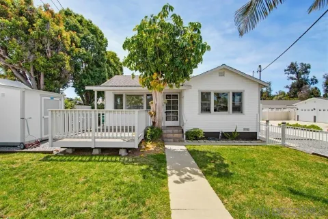 a view of a house with a yard and sitting area