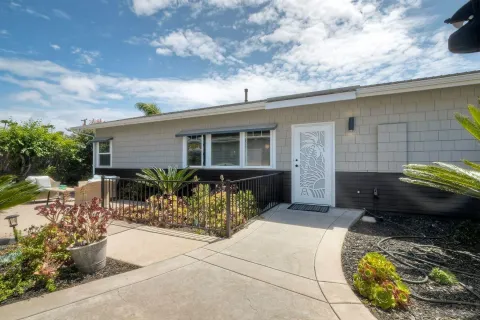 a kitchen with stainless steel appliances granite countertop a sink a stove a refrigerator cabinets and chairs