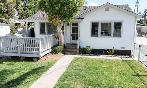 a view of a house with swimming pool and a yard