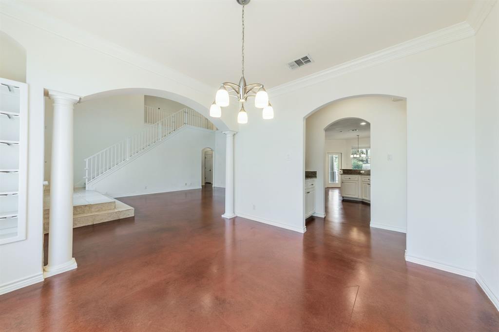 1704 Randolph Ridge Trail Austin, TX 78746 - Photo 8 of 23 Unfurnished dining area featuring concrete floors, a chandelier, and ornamental molding
