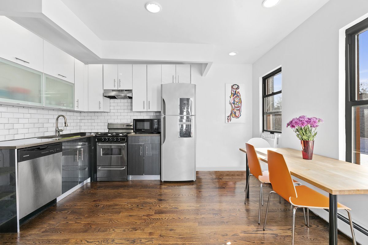 120 Ralph Avenue Brooklyn, NY 11221 - Photo 1 of 1 a kitchen with granite countertop a refrigerator and a stove top oven