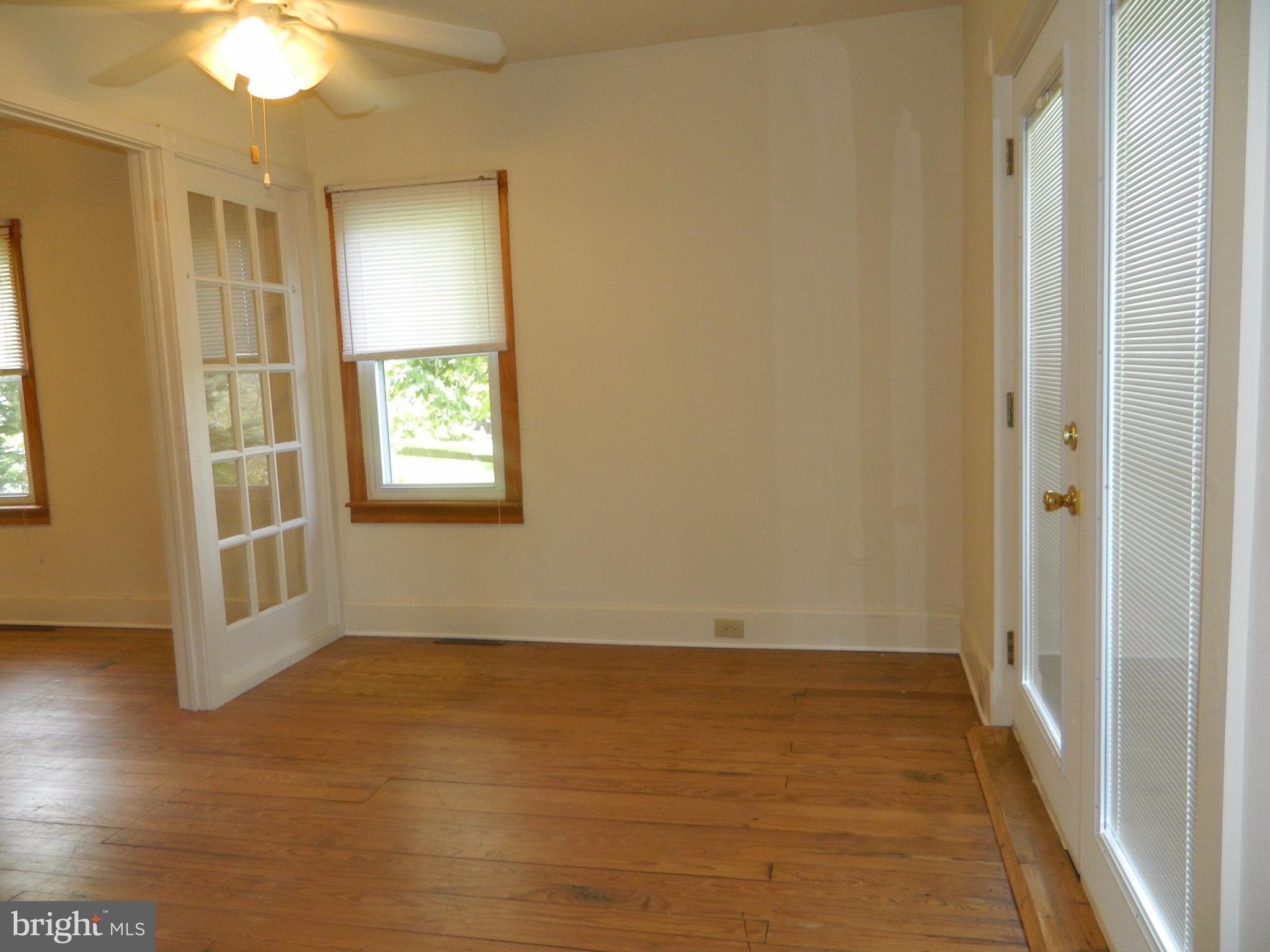 1601 Freeland Road Freeland, MD 21053 - Photo 11 of 29 an empty room with wooden floor and windows