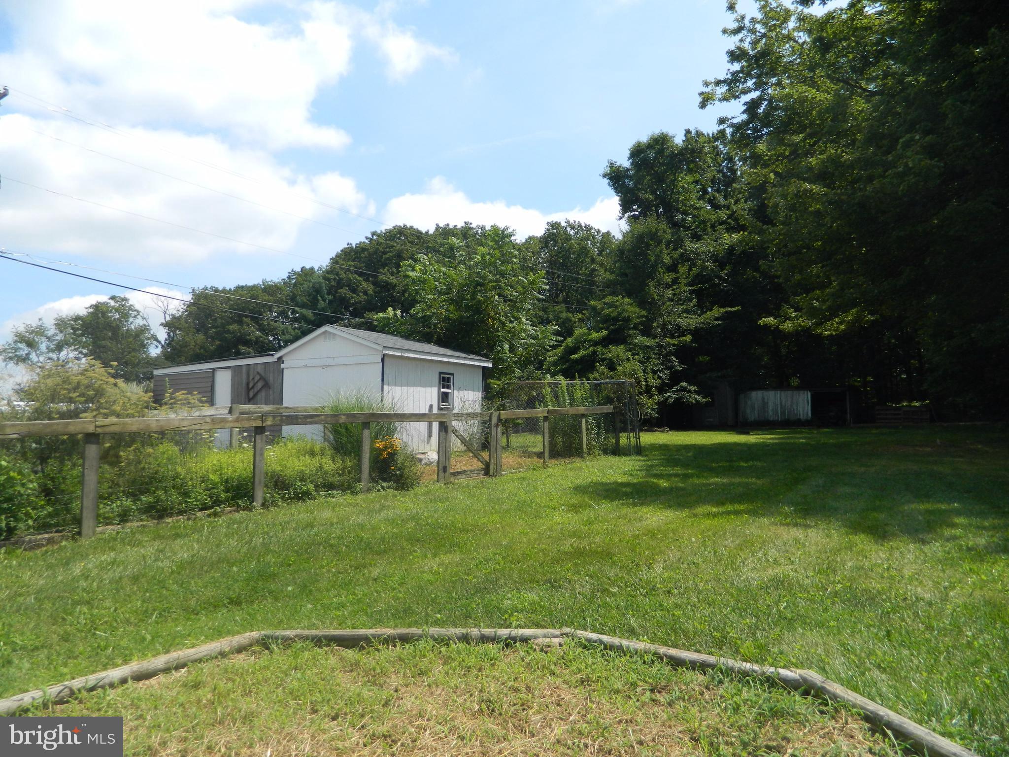 1601 Freeland Road Freeland, MD 21053 - Photo 26 of 29 a backyard of a house with plants and large trees