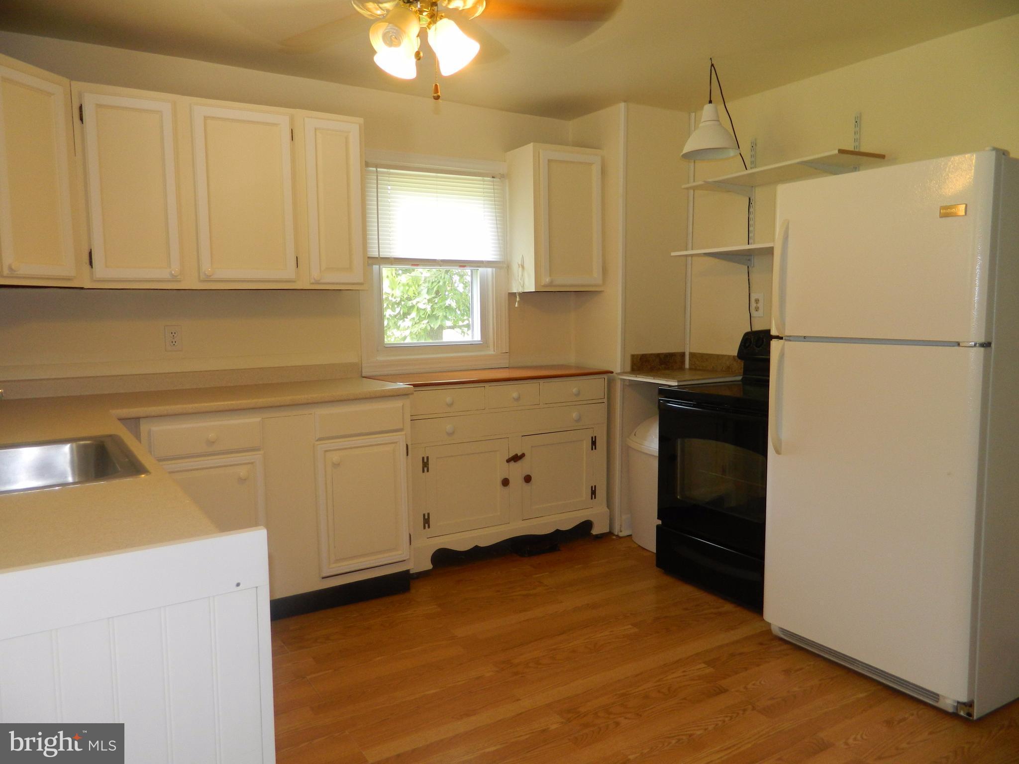 1601 Freeland Road Freeland, MD 21053 - Photo 7 of 29 a kitchen with a refrigerator sink stove and cabinets