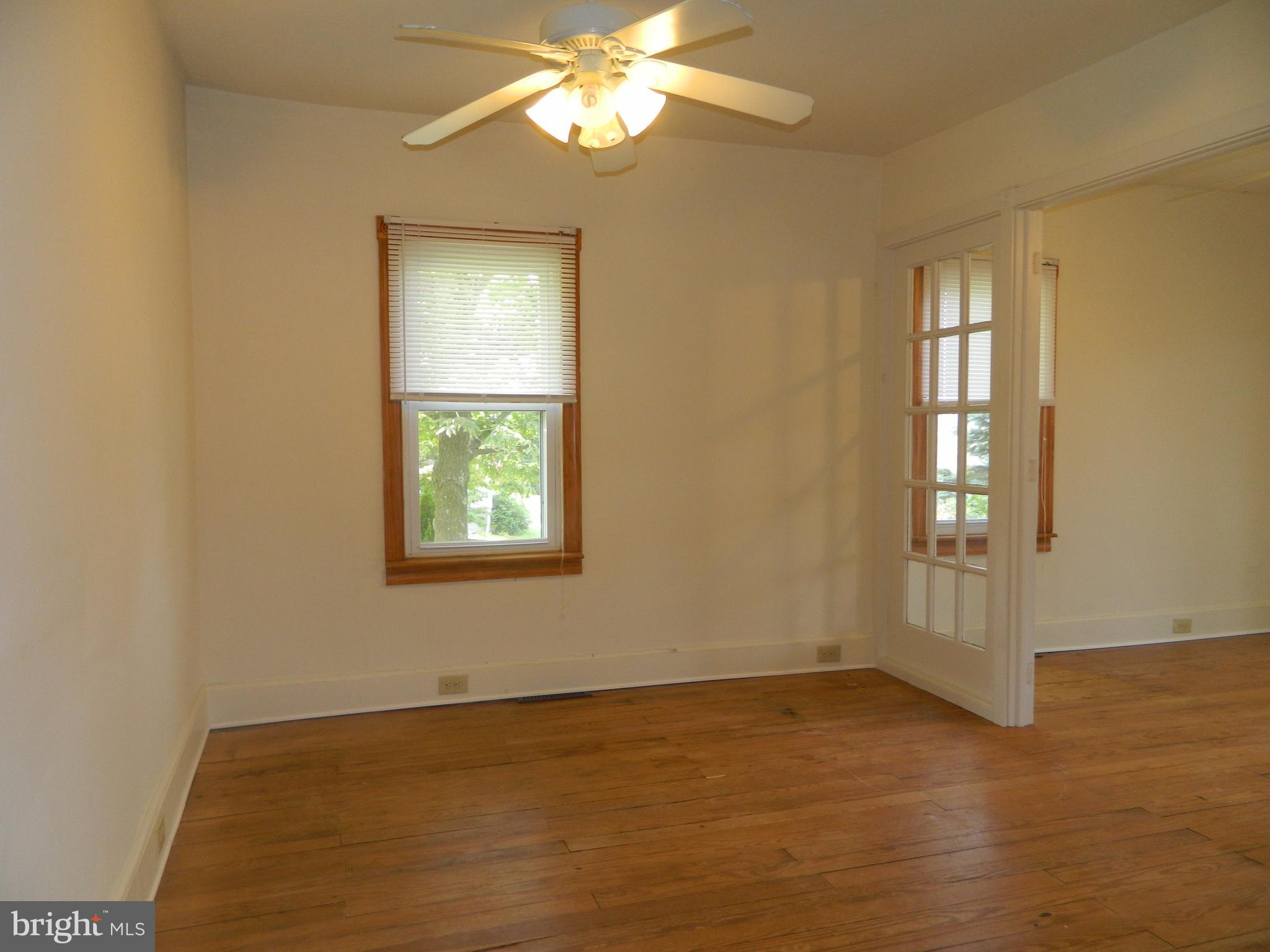 1601 Freeland Road Freeland, MD 21053 - Photo 10 of 29 a view of an empty room with wooden floor and a window