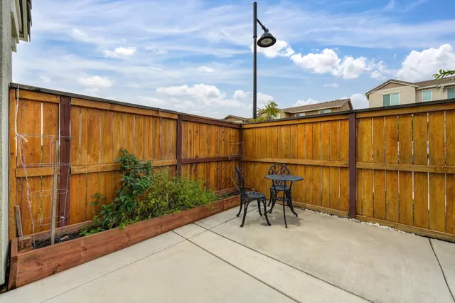 a patio with table and chairs