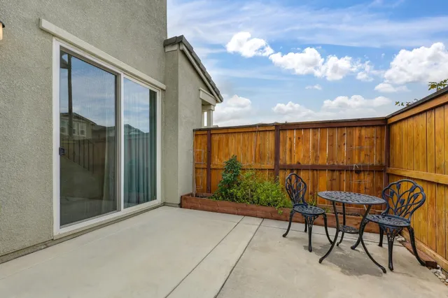 a balcony with table and chairs