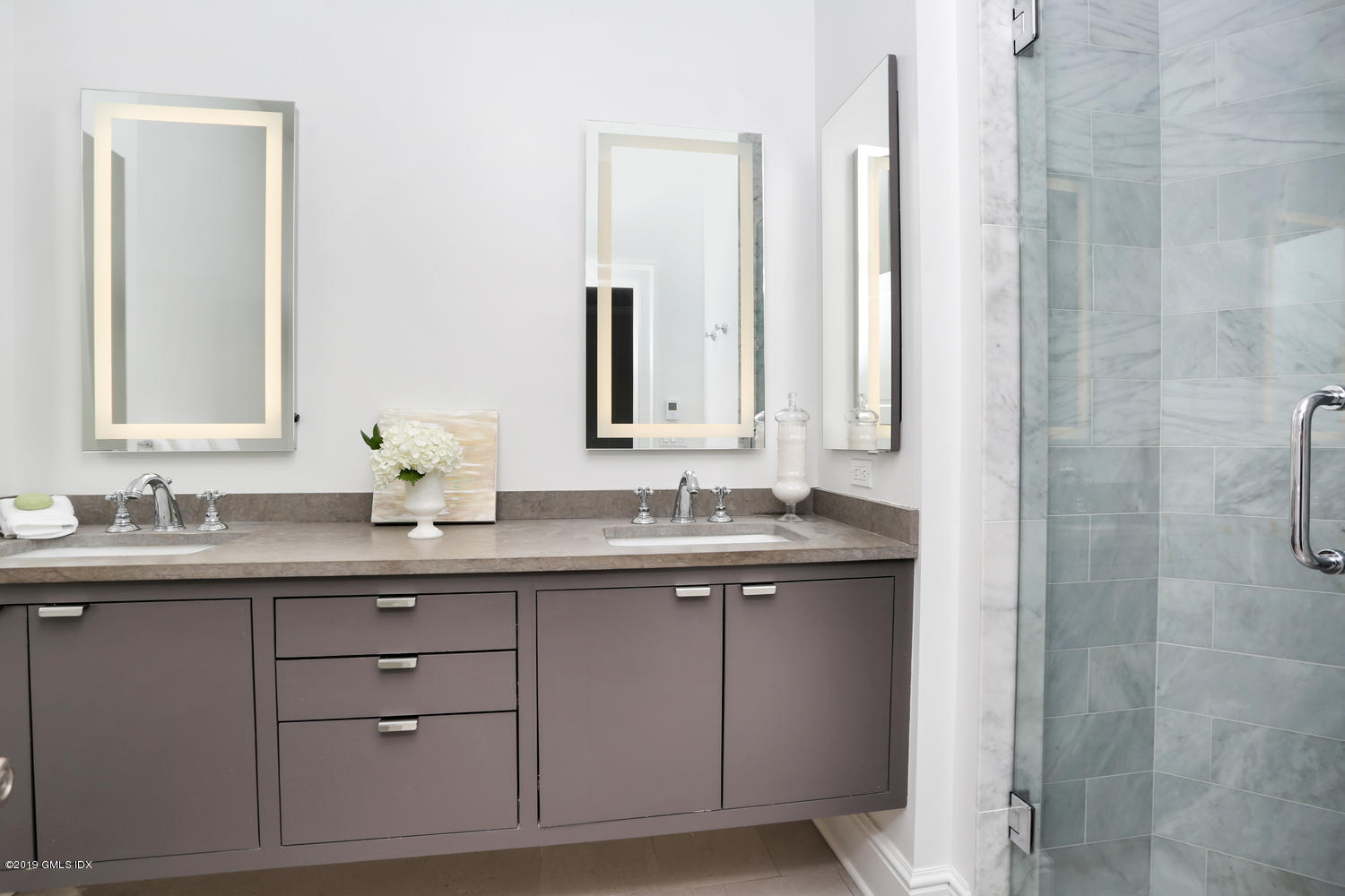 1 Lia Fail Way Cos Cob, CT 06807 - Photo 12 of 26 a bathroom with a double vanity sink and mirror