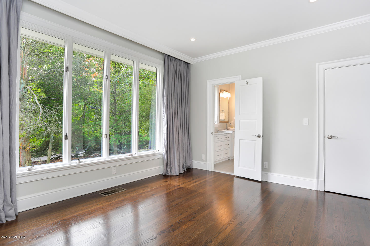 1 Lia Fail Way Cos Cob, CT 06807 - Photo 13 of 26 a view of an empty room with wooden floor and a window