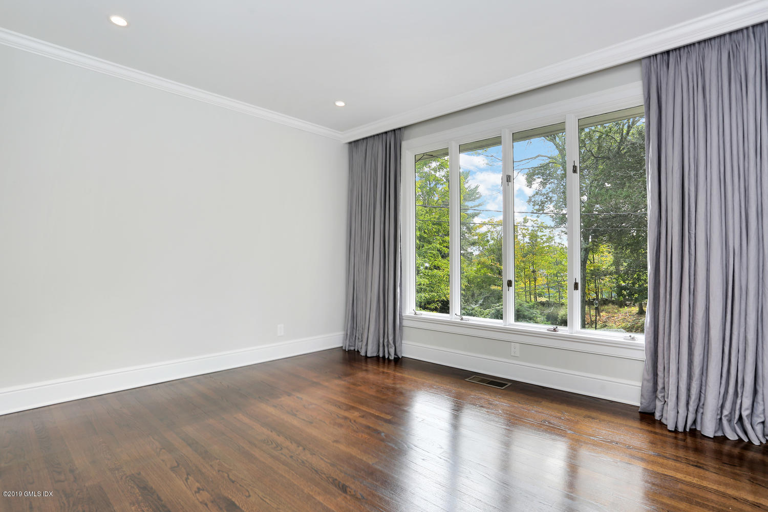 1 Lia Fail Way Cos Cob, CT 06807 - Photo 14 of 26 a view of wooden floor and windows in a room