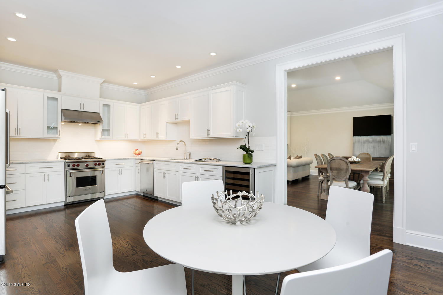 1 Lia Fail Way Cos Cob, CT 06807 - Photo 7 of 26 a kitchen with a dining table chairs and white cabinets