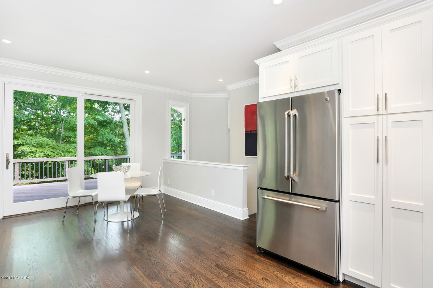 1 Lia Fail Way Cos Cob, CT 06807 - Photo 9 of 26 a kitchen with a refrigerator a stove and wooden floor next to a large window