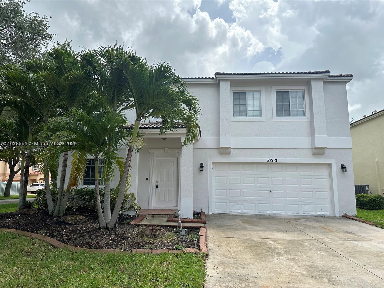 a house with a tree in the grass