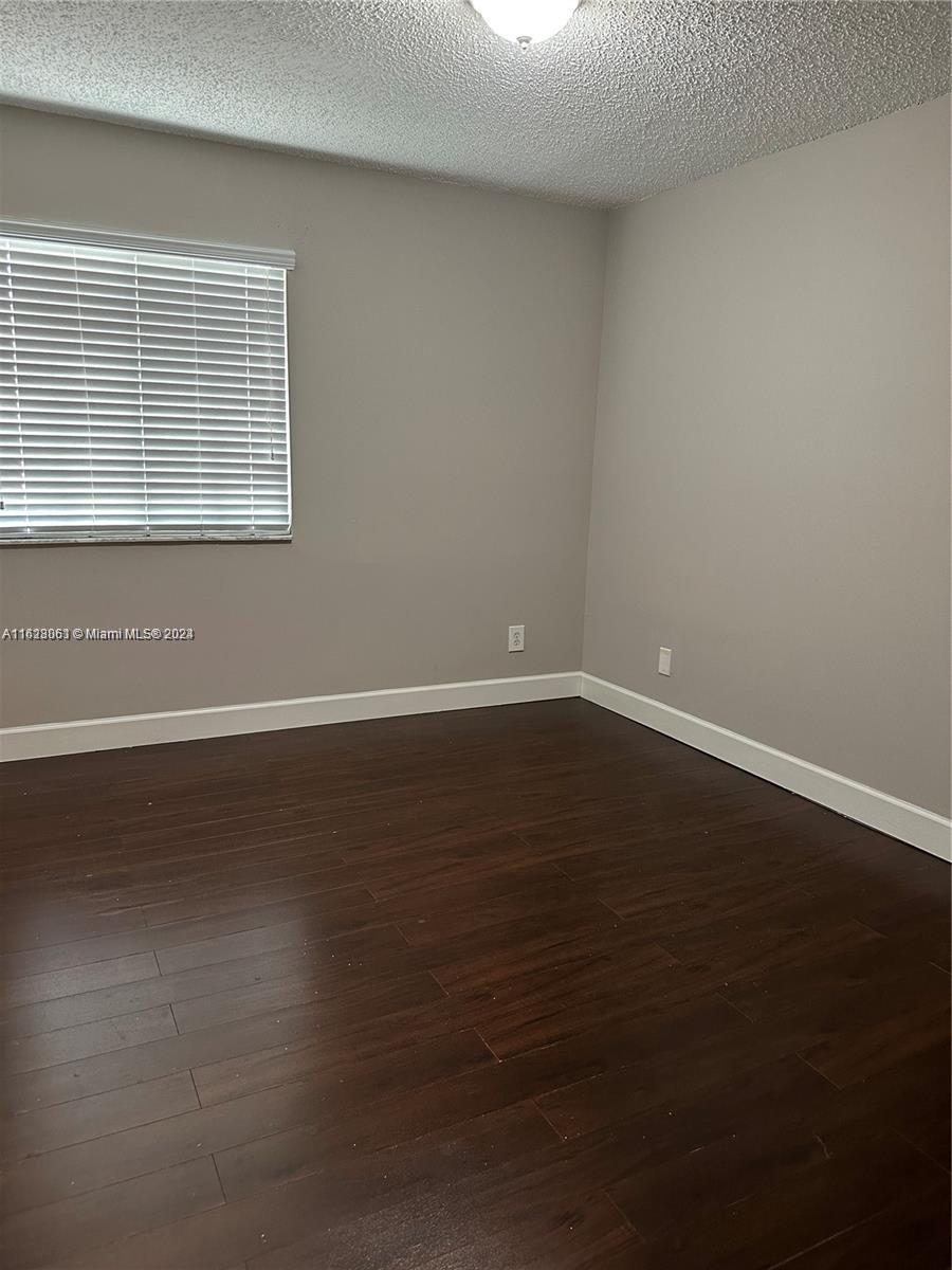 Avalon Miramar, FL 33025 - Photo 11 of 14 a view of wooden floor and brick walls