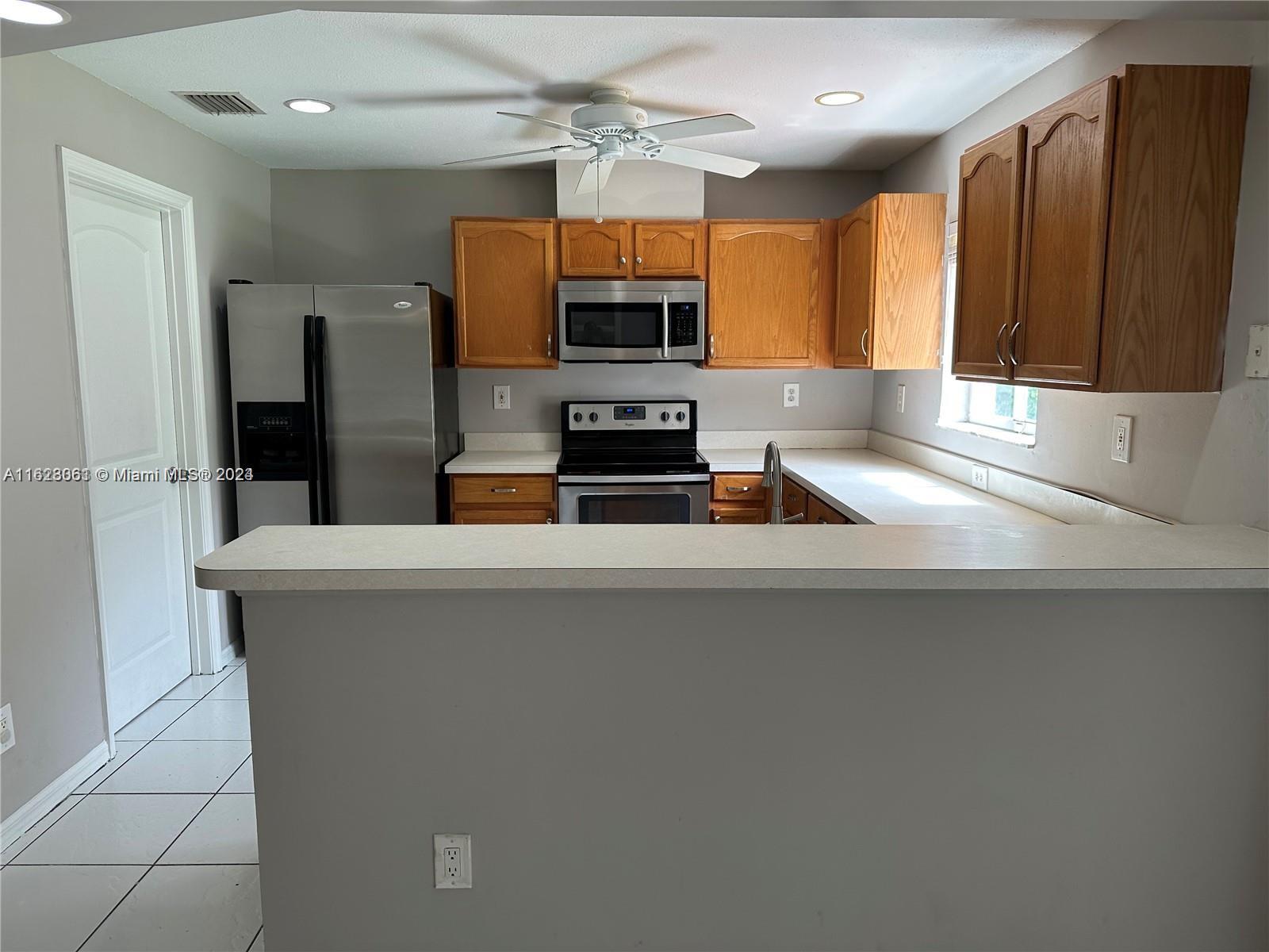 Avalon Miramar, FL 33025 - Photo 4 of 14 a kitchen with stainless steel appliances a stove a refrigerator and a sink