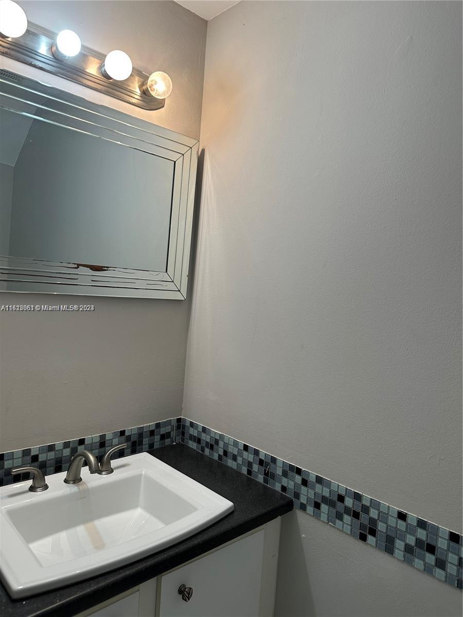 Avalon Miramar, FL 33025 - Photo 6 of 14 a bathroom with a sink and a mirror