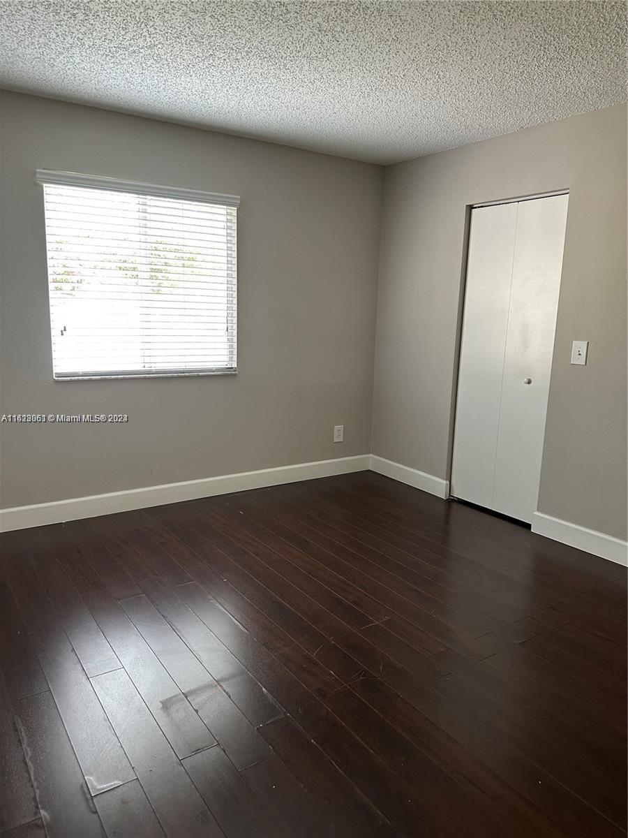 Avalon Miramar, FL 33025 - Photo 7 of 14 an empty room with wooden floor and windows