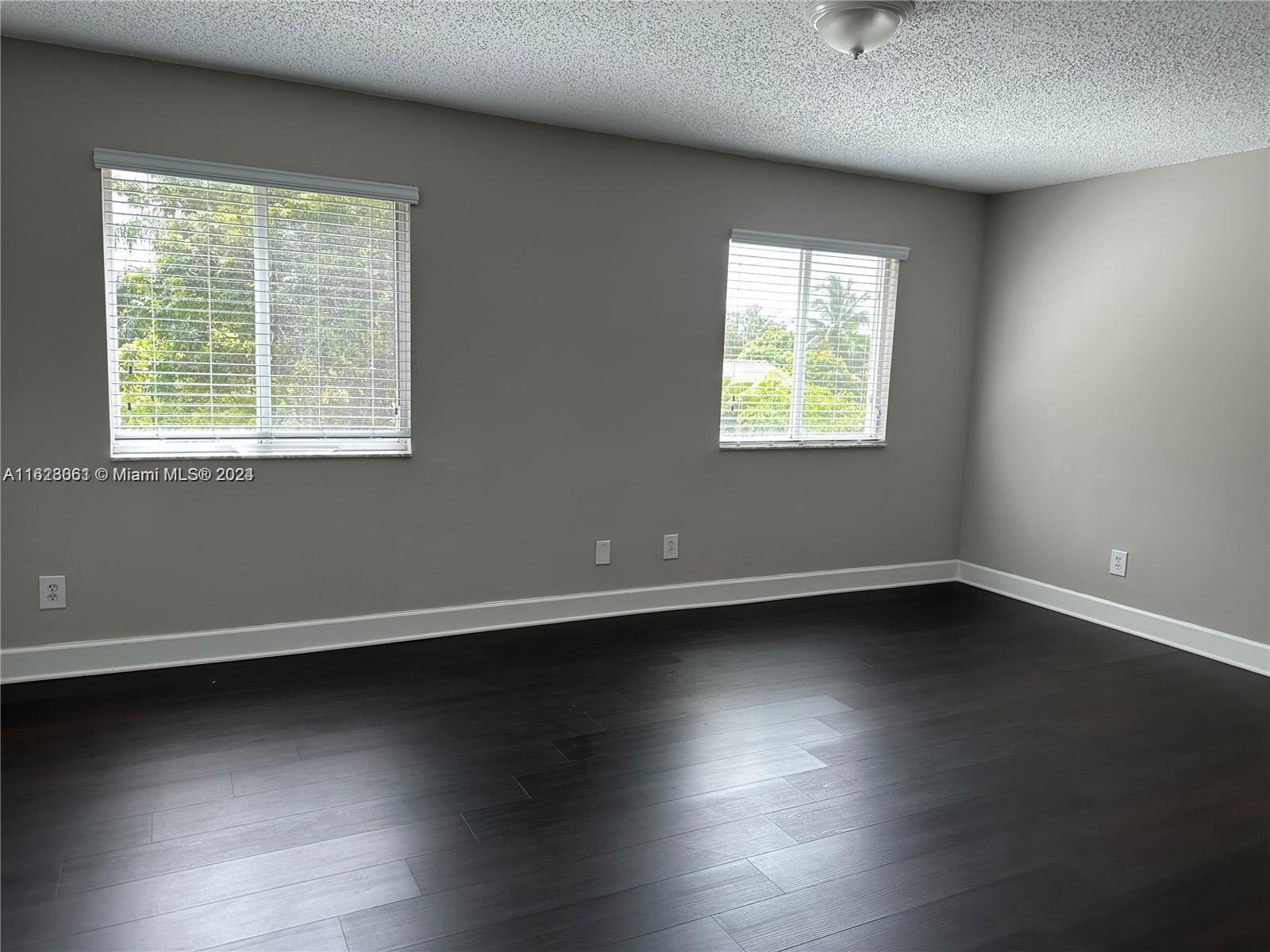 Avalon Miramar, FL 33025 - Photo 8 of 14 an empty room with wooden floor and windows