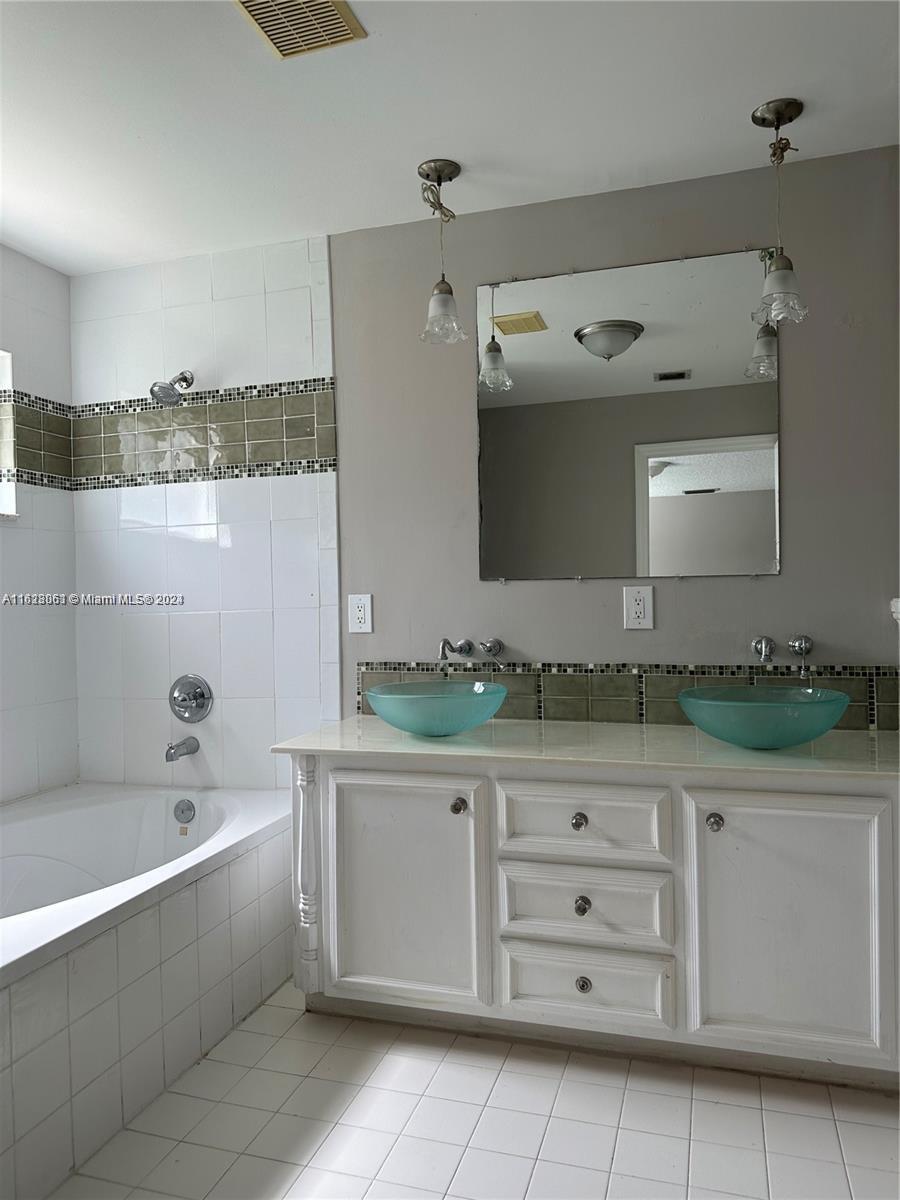 Avalon Miramar, FL 33025 - Photo 9 of 14 a bathroom with a bathtub and a sink