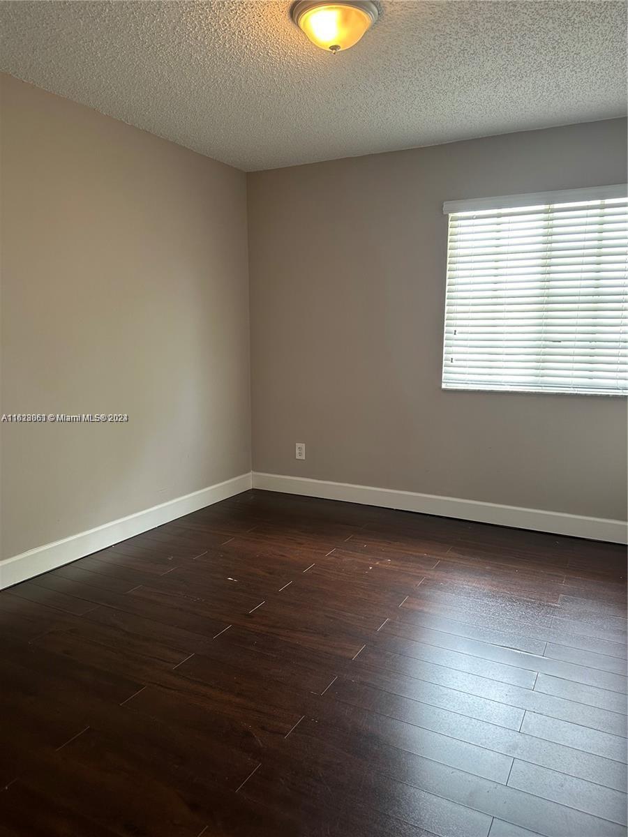 Avalon Miramar, FL 33025 - Photo 10 of 14 a view of a room with wooden floor and a window