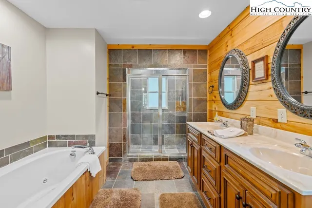 a bathroom with a tub sink and mirror