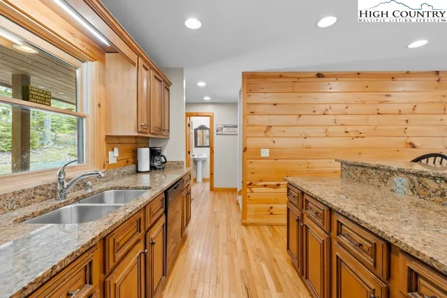 a kitchen with stainless steel appliances granite countertop a sink and stove top oven
