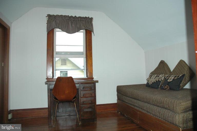 624 North Bend Road Baltimore, MD 21229 - Photo 12 of 22 a bedroom with a bed chair and window