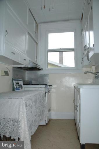 624 North Bend Road Baltimore, MD 21229 - Photo 7 of 22 a kitchen with stainless steel appliances granite countertop a sink a stove and a refrigerator